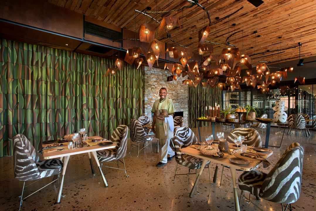 staff serving food in dining area at &Beyond Tengile River Lodge Sabi Sands