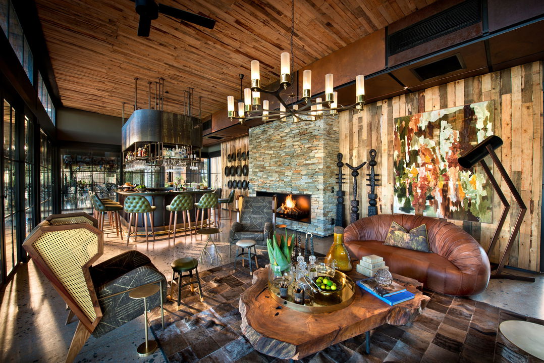 fireplace in lounge of main lodge at &Beyond Tengile River Lodge Sabi Sands