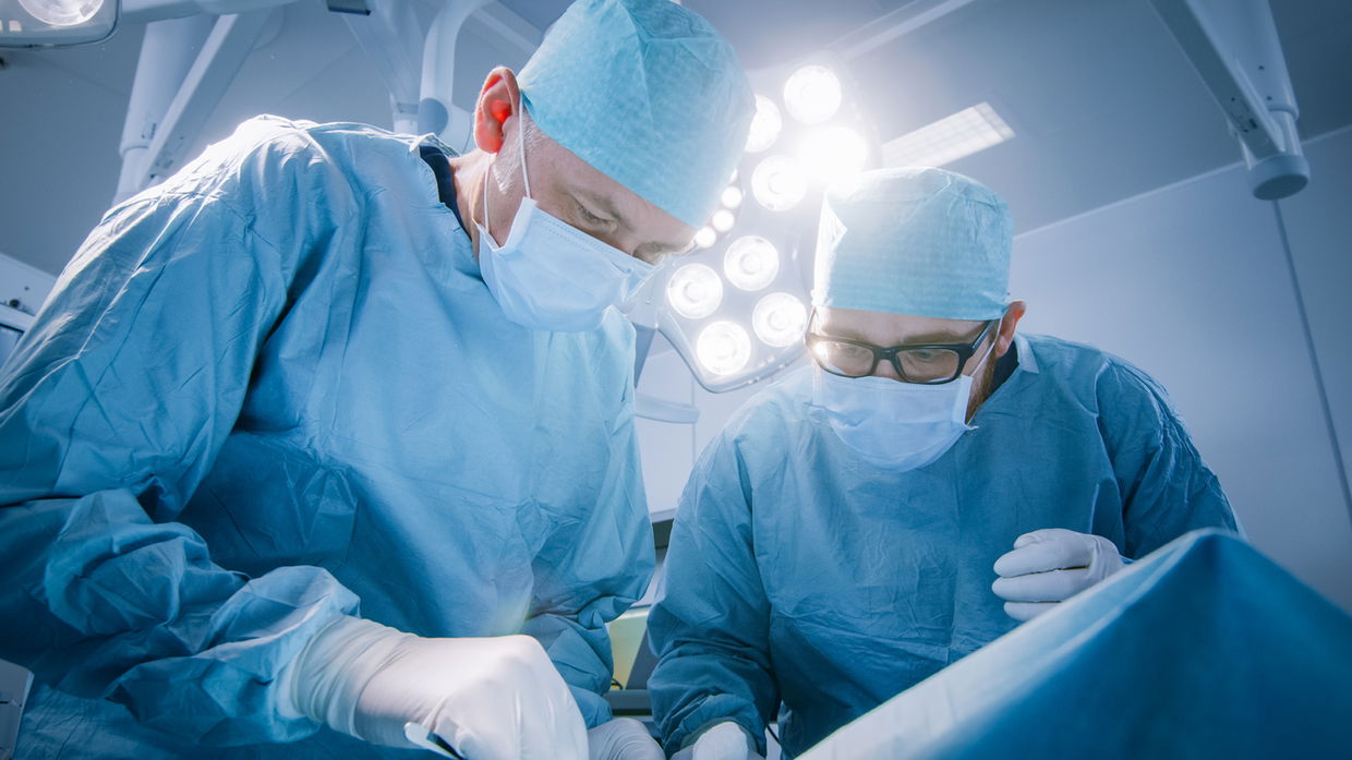 two surgeons operating on patient