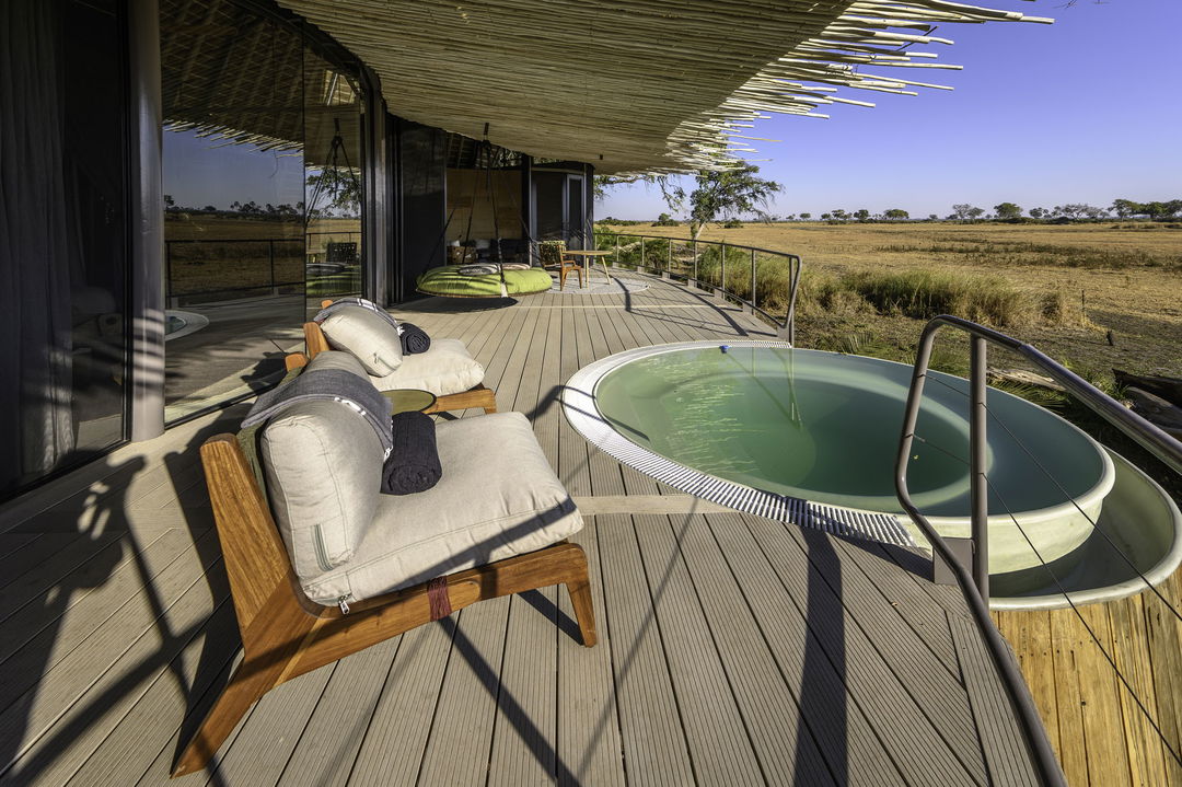 splash pool with chairs on private deck at room by  Jao Camp Botswana