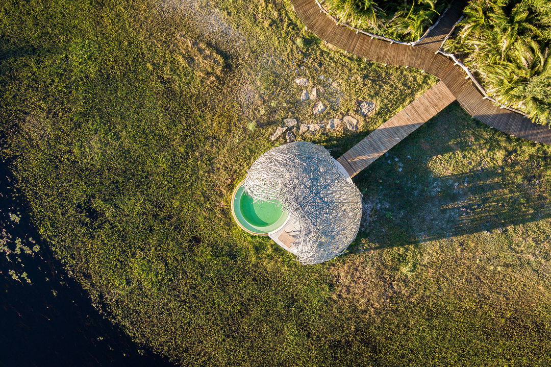 aerial view of grass dome and walkways at Jao Camp Wilderness 