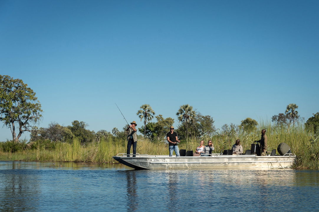 fishing for tigerfish on a boat at Jao Camp Wilderness Okavango Delta Botswana