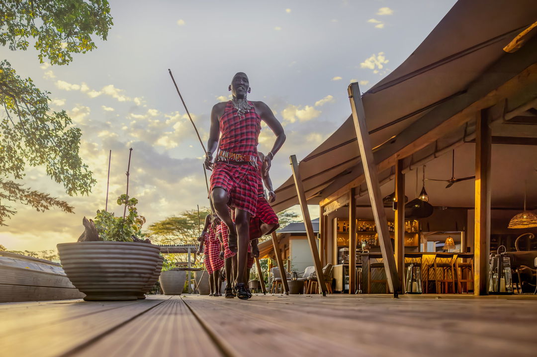 masai warrior on the main viewing deck of the JW Marriot Masai Mara Kenya