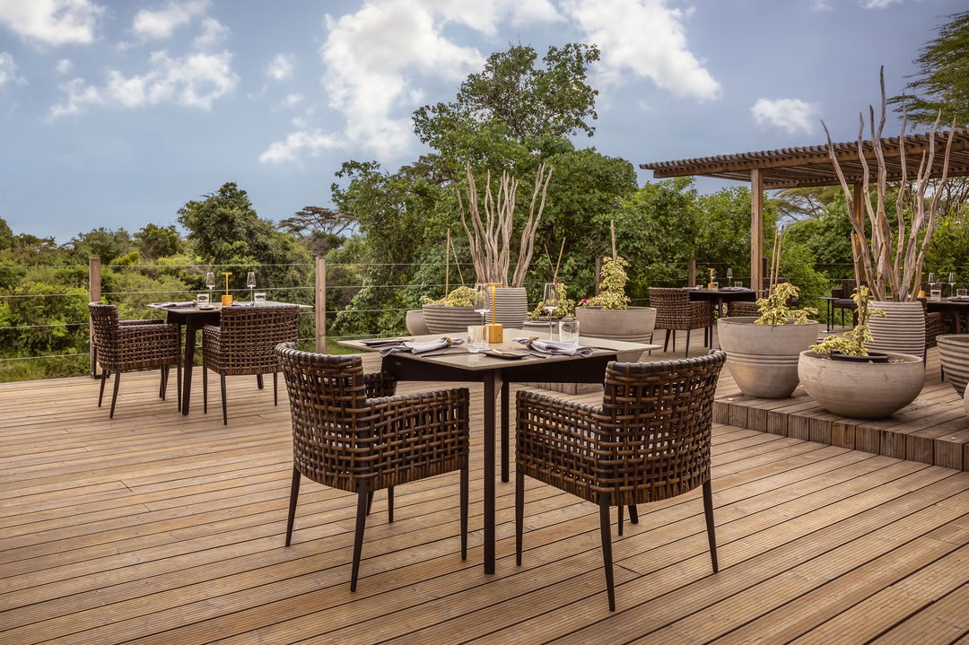 table set for dinner on the deck of the main loadge at the JW Marriot Masai Mara Kenya