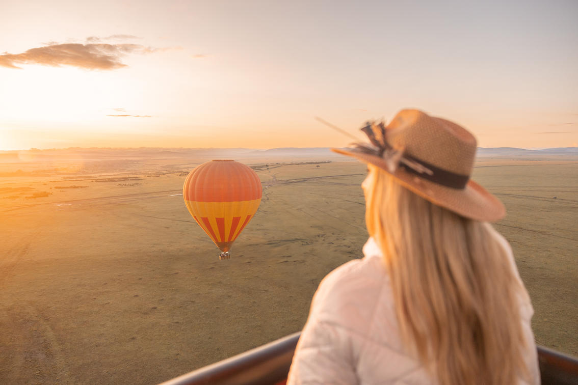 lady guest in a hot air baloon over the plains of the mara at JW Marriot Kenya