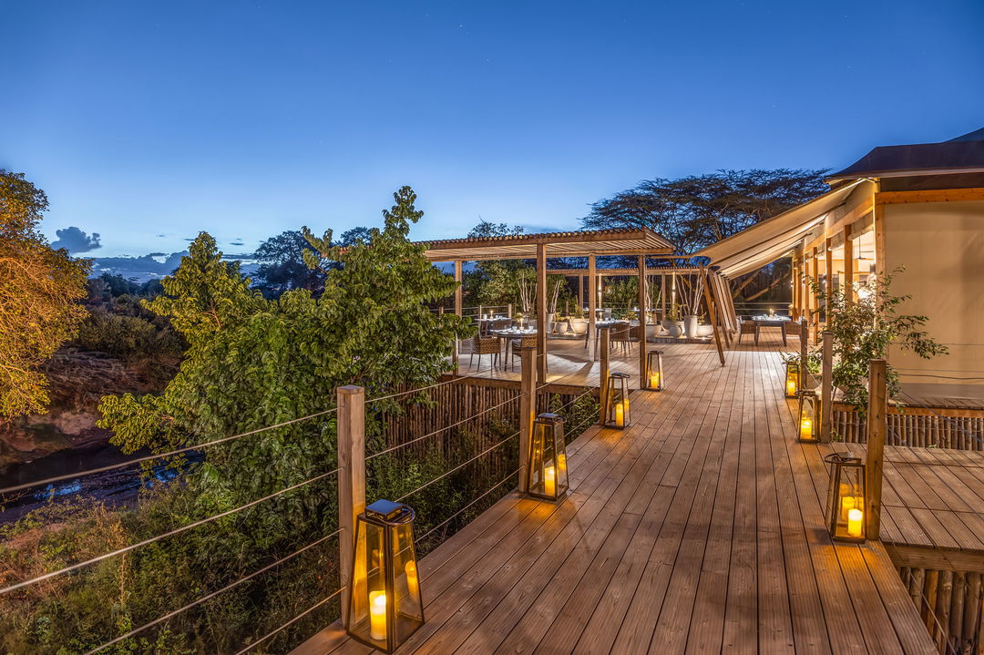 outdoor dining deck set for supper at the JW Marriot Masai Mara Kenya