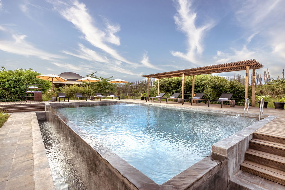 generated image of the main swimming pool at at he JW Marriot Masai Mara Kenya