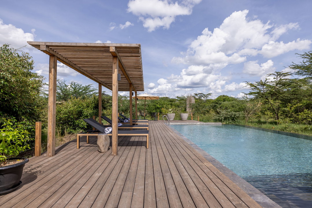 main swimming pool and deck with loungers at the JW Marriot Masai Mara Kenya