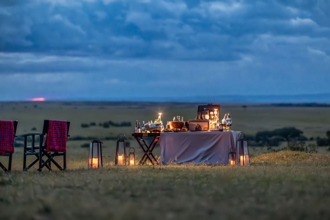 table set with sundowners on the savannah at sunset by the JW Marriot Masai Mara Kenya