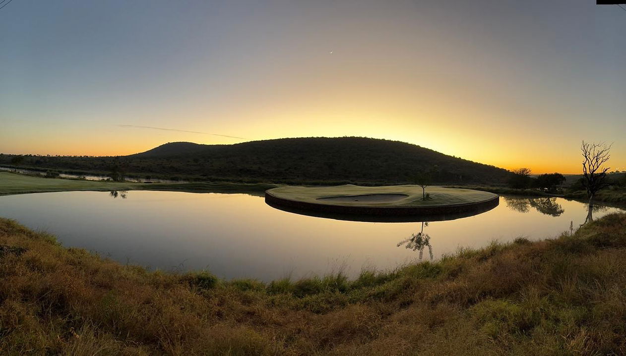 island green at kambaku golf course at sunset