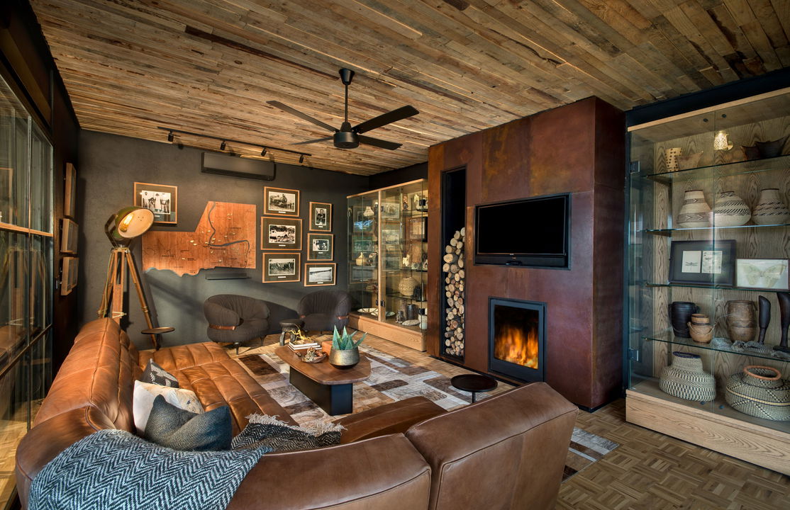 fireplace in lounge at &Beyond Tengile River Lodge Sabi Sands