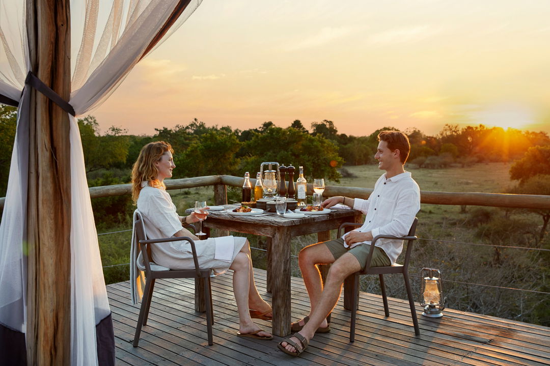 couple having supper on deck of Chalkley treehouse lion sands
