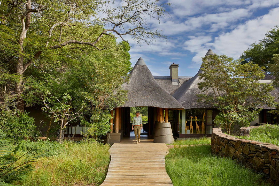 guest in front of walkway to Narina lodge entrance