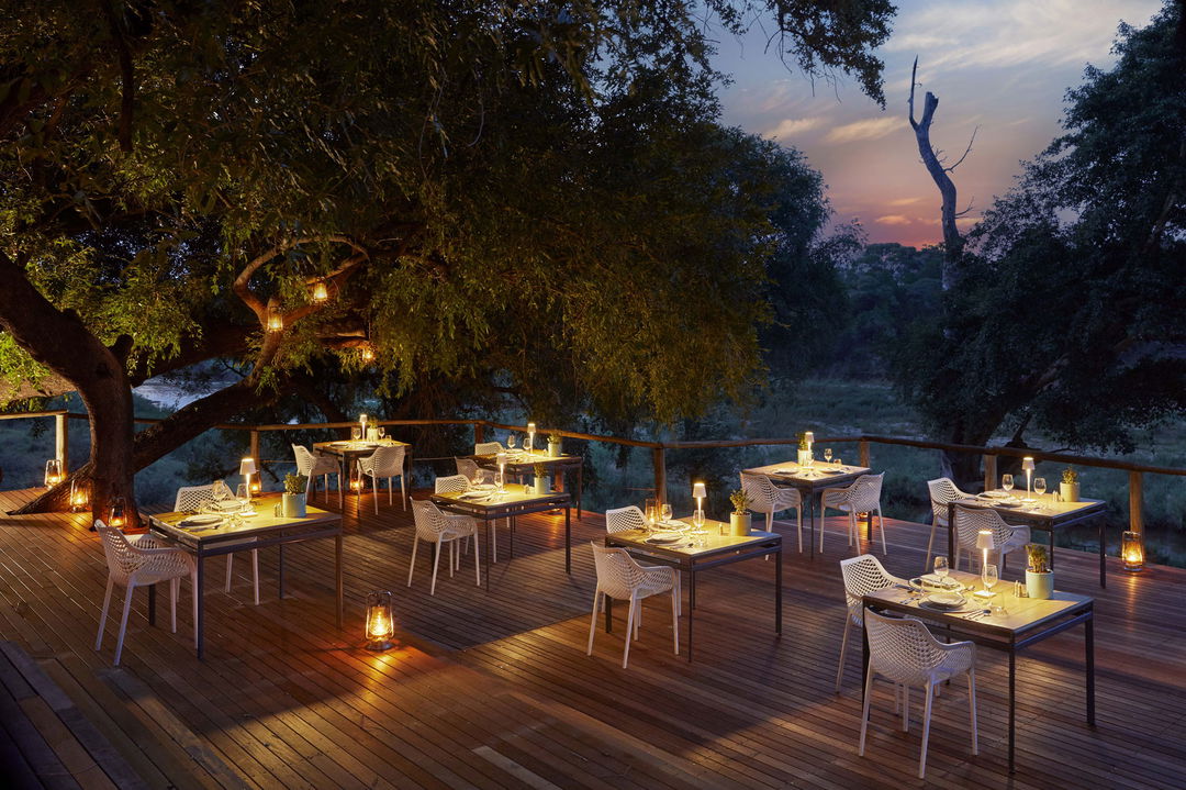 dinner setting at night on main deck of Narina lodge Lion Sands