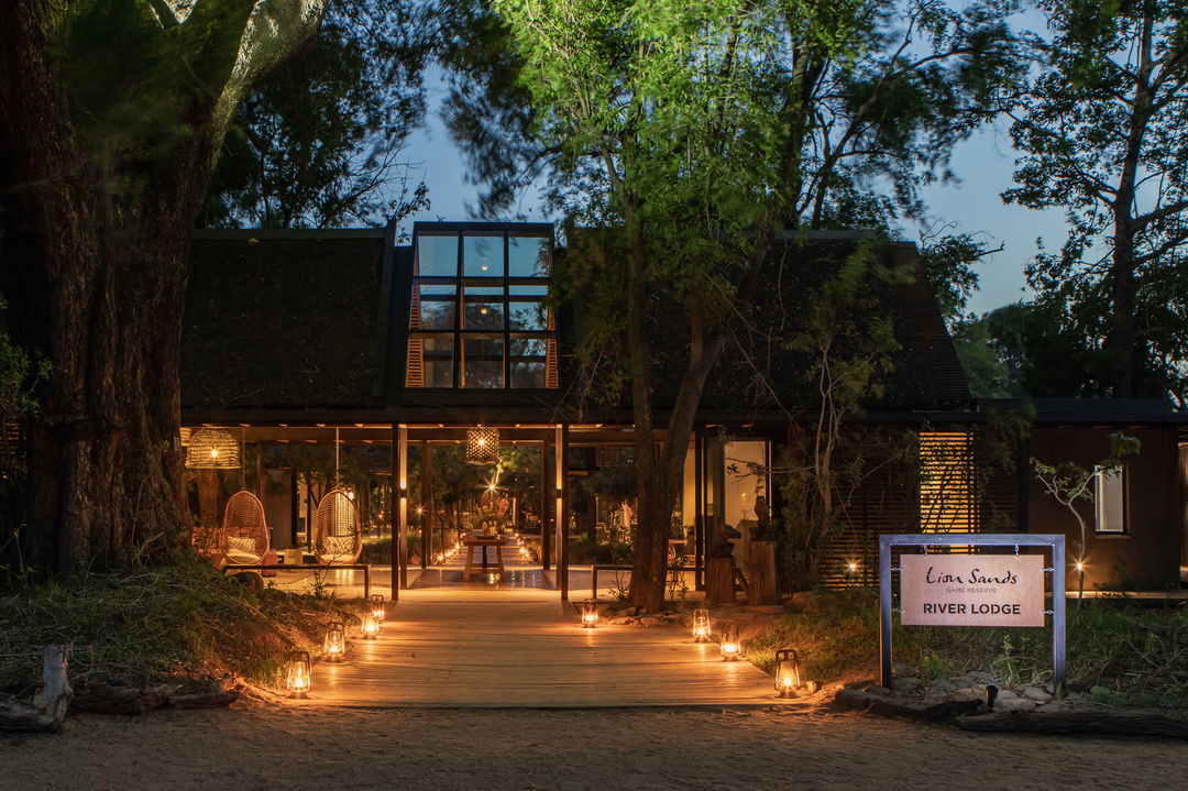 entrance walkway of lion sands river lodge at night