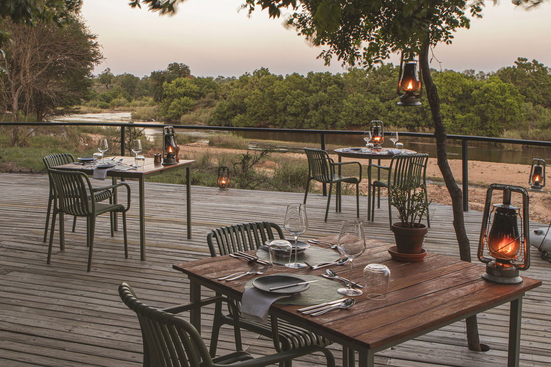 firedeck view with chairs and table at river lodge lion sands