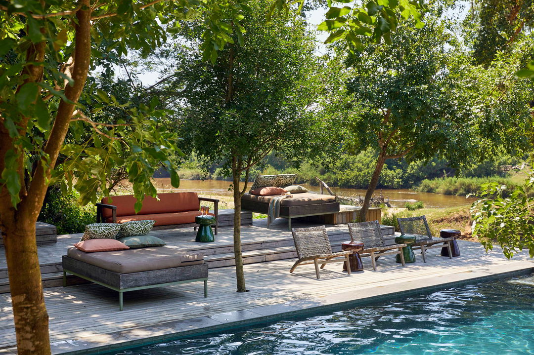 River Lodge main pool and deck with loungers by Lion Sands Game Reserve