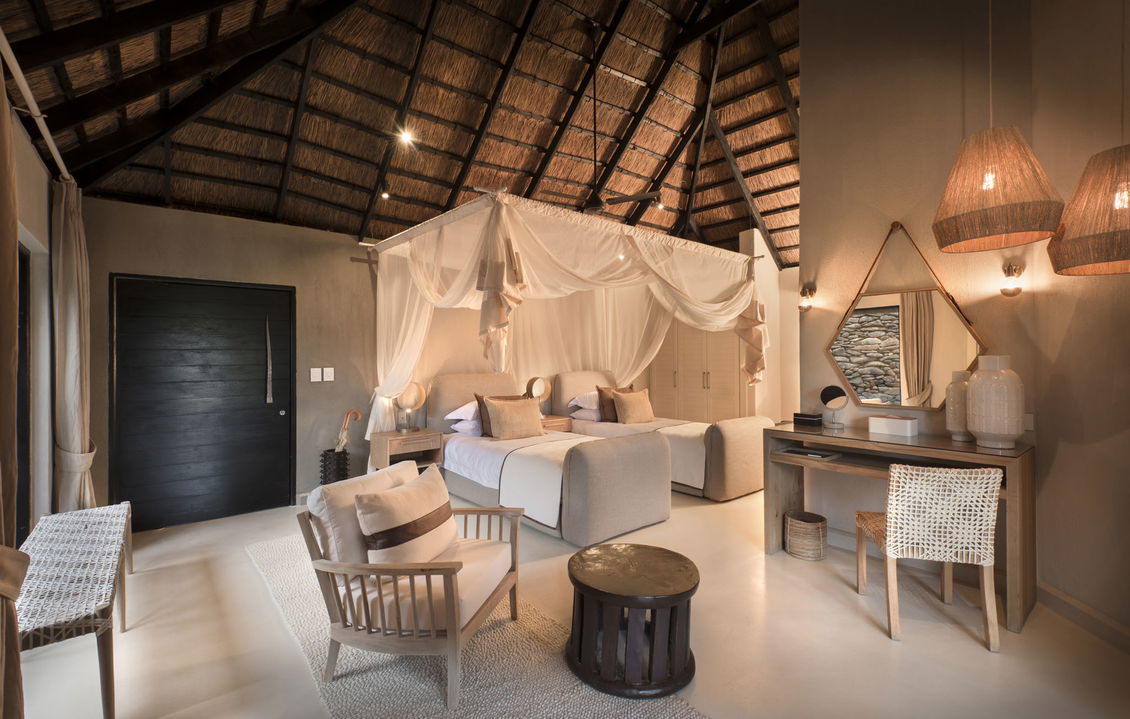 inside view of bedroom by lion sands river lodge