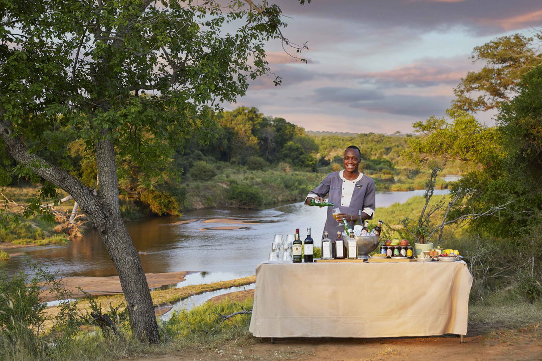 table with refreshments under tree at tinga lodge lion sands