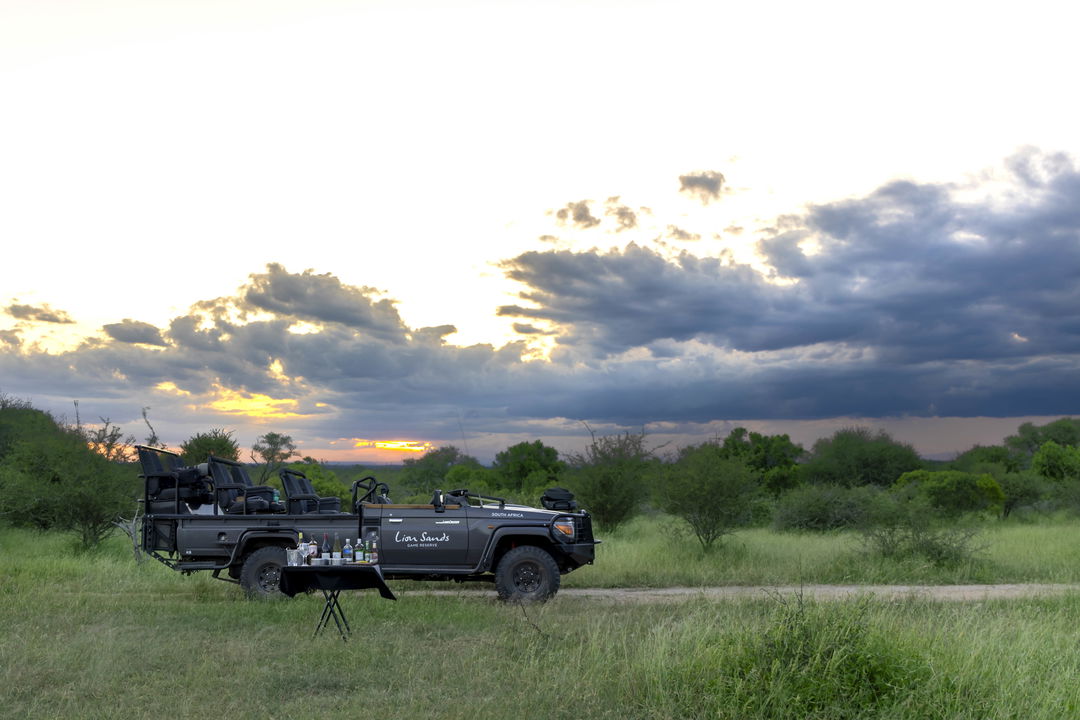 table with sundowners at safari vehicle by Lion Sands Game Reserve