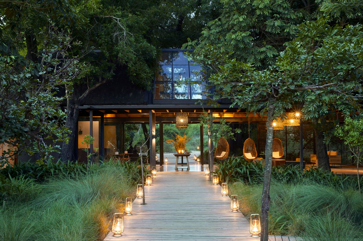 exterior view of river lodge at sunset by Lion Sand Game Reserve