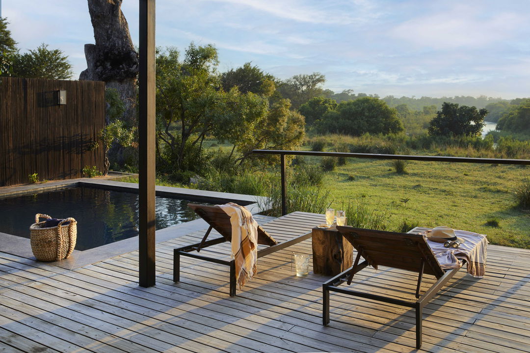 suite with private deck and loungers by pool at River lodge Lion Sands Game Reserve