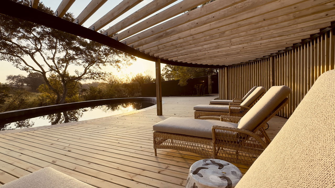 tinga lodge suite with pool on deck and loungers by Lion Sands Game Reserve