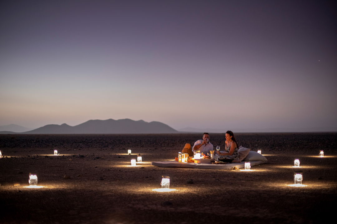 romantic dinner in the open air on mattress at little Kulala camp wilderness Namibia