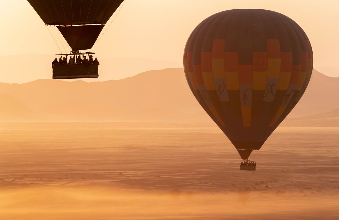hot air balloons over desert at little Kulala camp wilderness Namibia