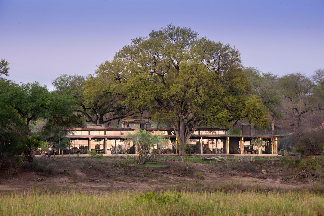 outside view of lodge facility from river at &Beyond Tengile River Lodge Sabi Sands