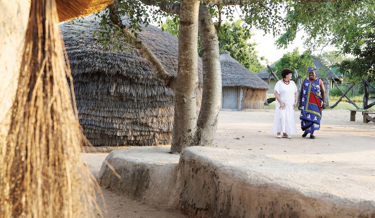 lady guest walking with a tribal lady of a village near Londolozi game reserve