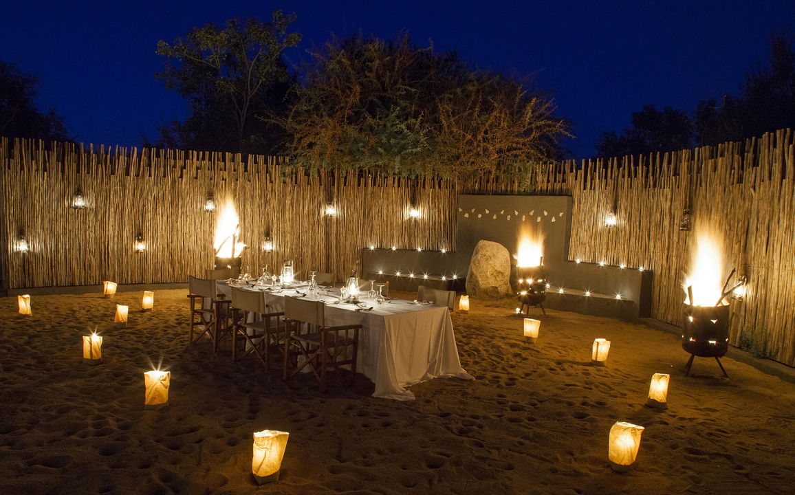 dinner setting in fireplace boma of Pioneer Camp Londolozi