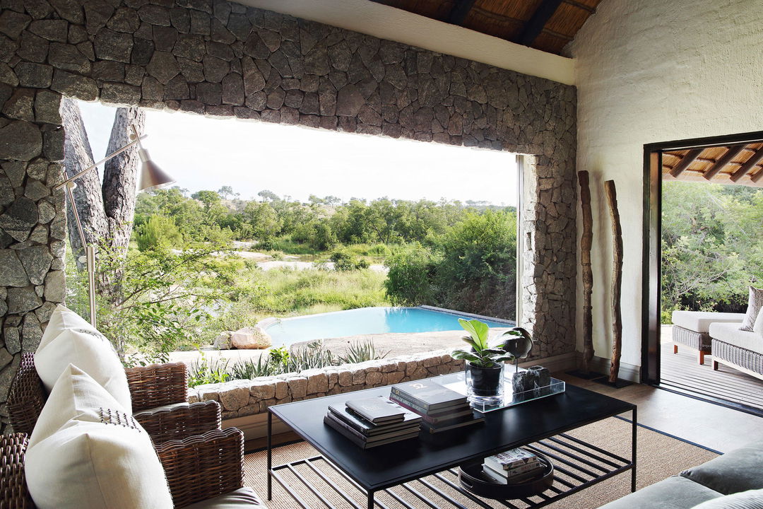 lounge area of a granite suite with a view at Lodolozi game reserve