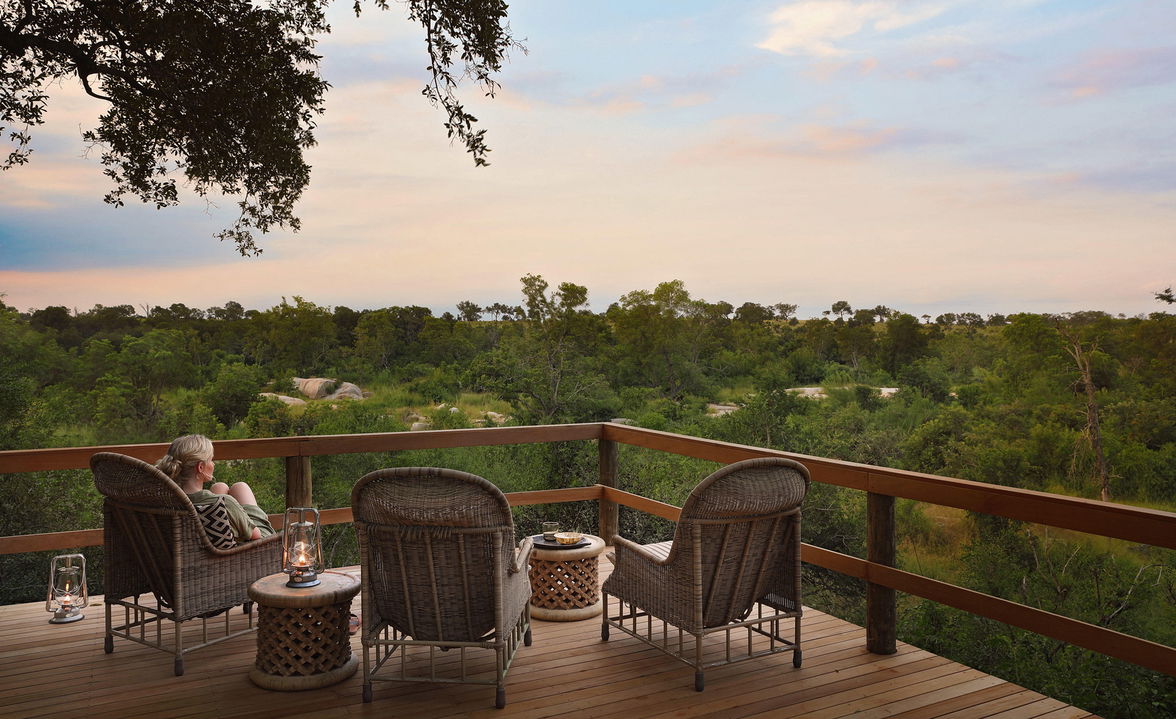 chairs on the lookout deck of Londolozi Pioneer camp at sunset