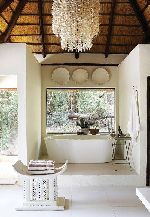 bathtub in bathroom of a suite at Tree camp Londolozi