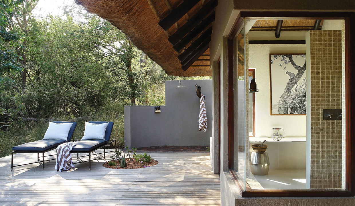 chairs on the pool deck of a suite at Tree camp Londolozi