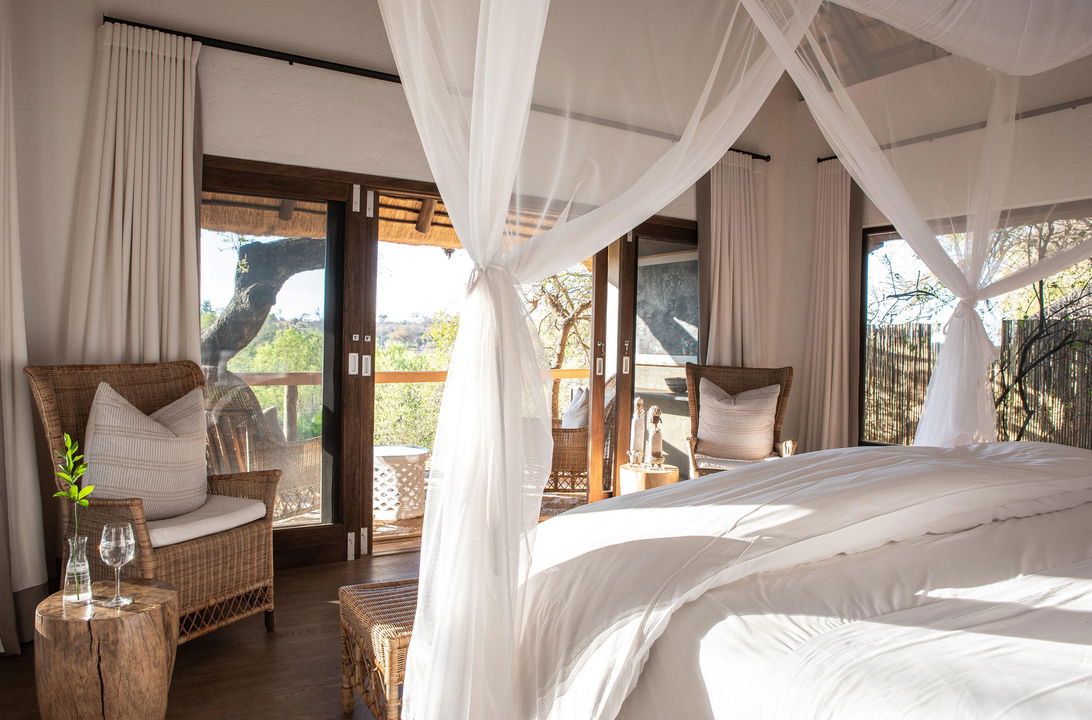 view from bedroom on bush and deck of superior chalet at Varty camp Londolozi game Reserve