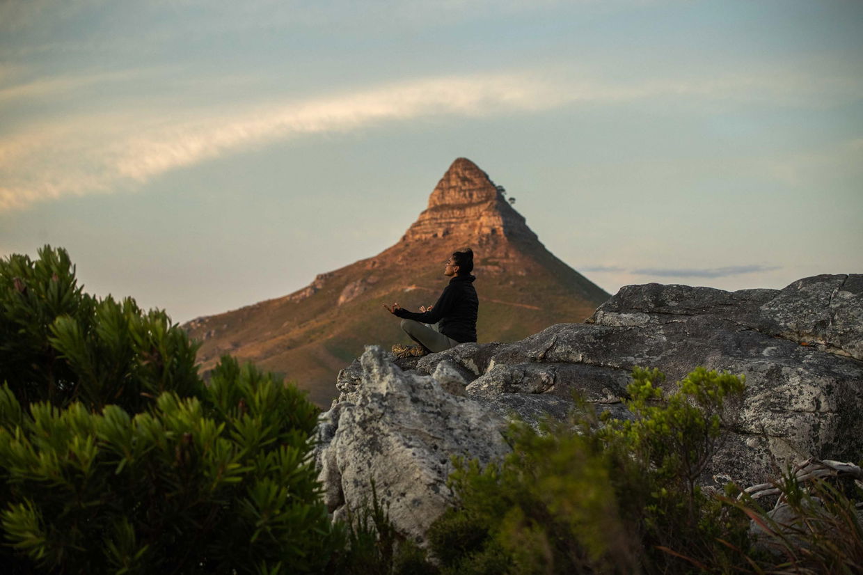 lady in yoga pose on rock at table mountain cape town