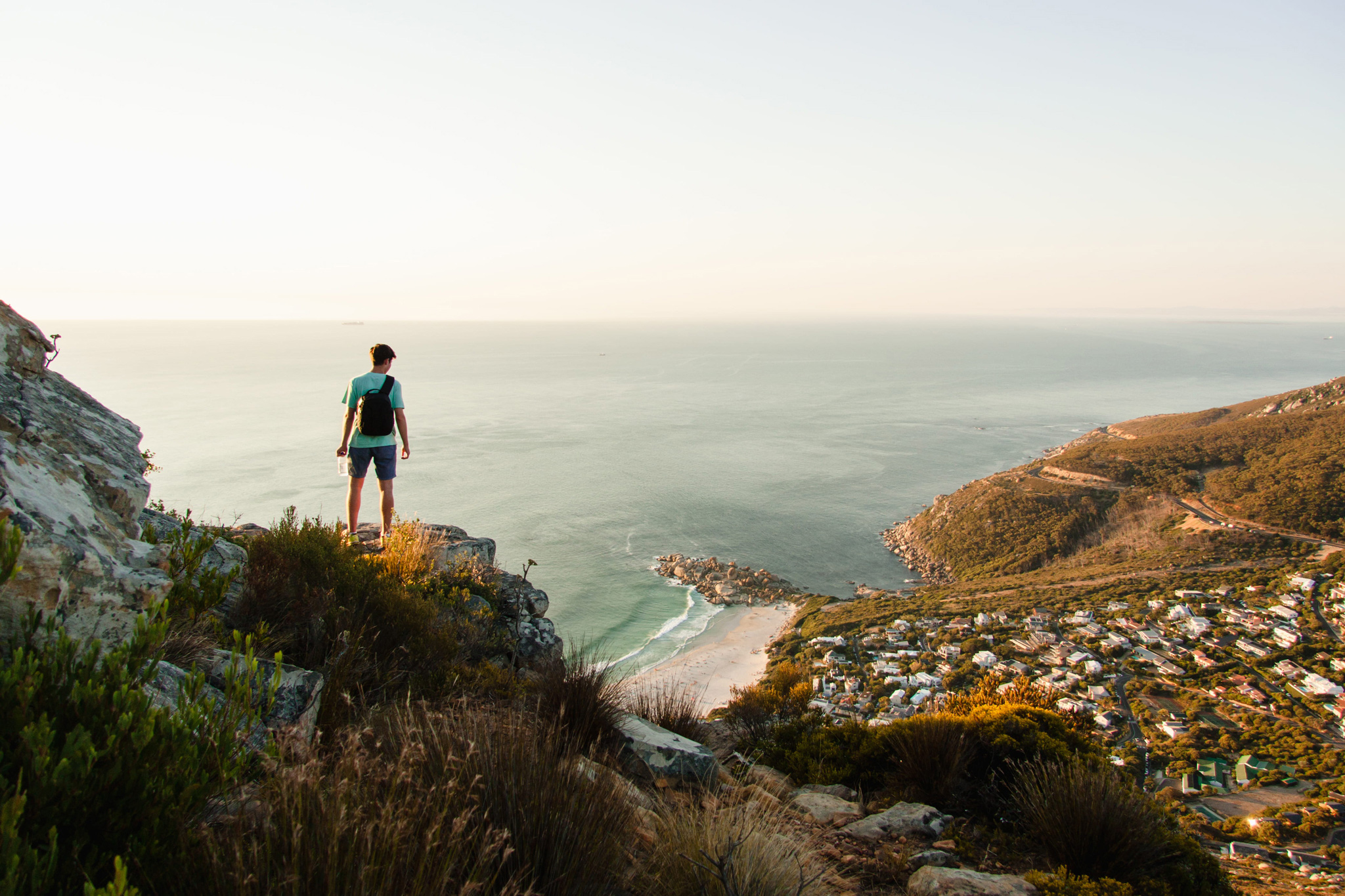 man on table mountain looking down at cape town below