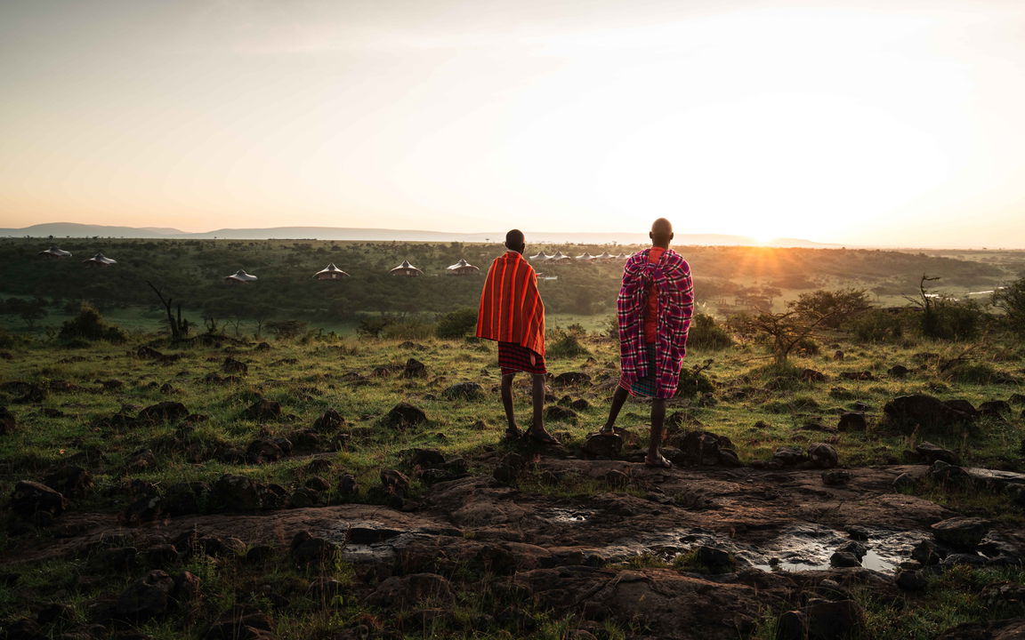 Masai trackers on a hill looking over plain at Mahali Mzuri Kenya Masai Mara
