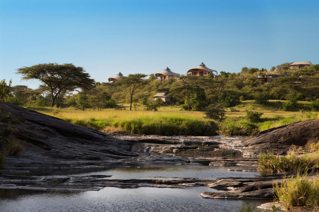 view from the river of the main lodge at Mahali Mzuri Kenya Masai Mara