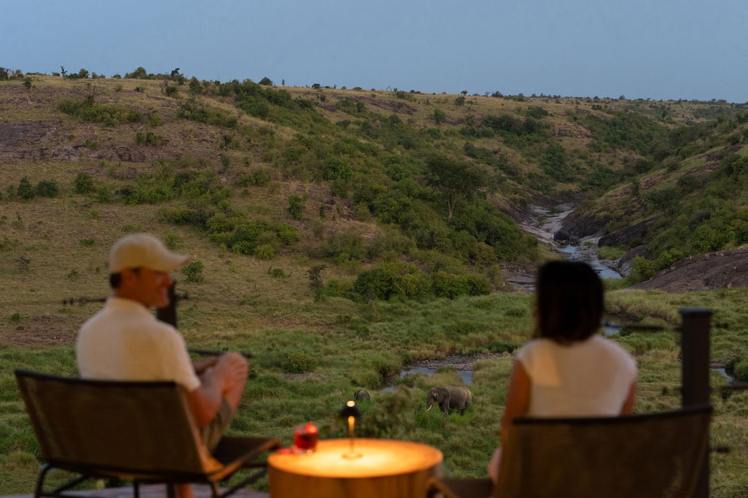 sundowners on deck of suite with elephant below at Mahali Mzuri Kenya Masai Mara