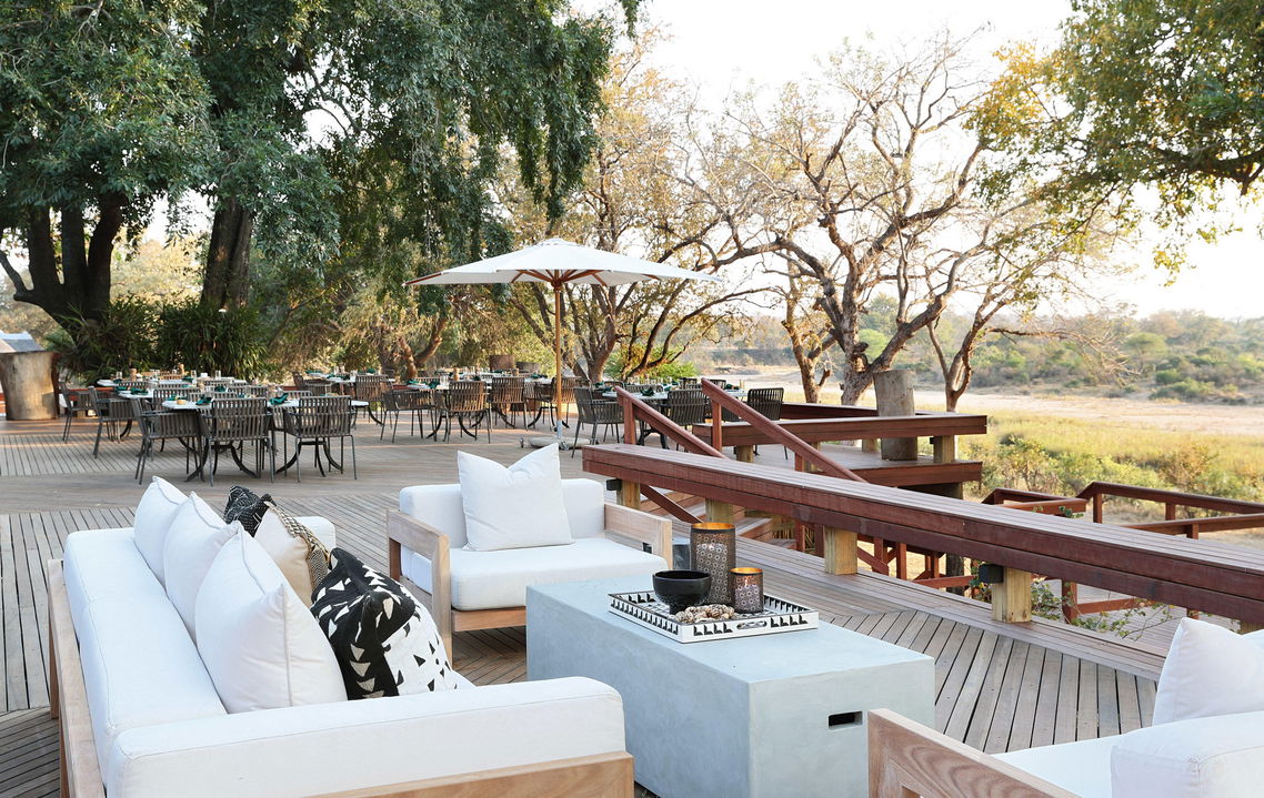 main deck with chairs and couches at MalaMala Main Game lodge