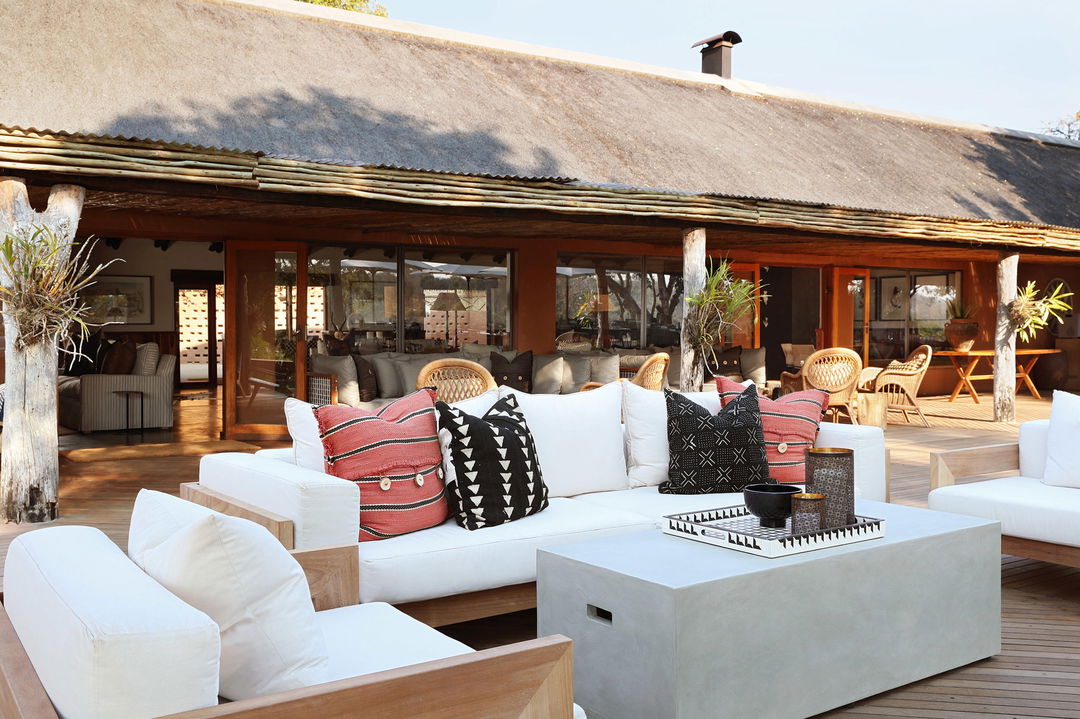 outside deck with couches and pillows at MalaMala Main Game lodge