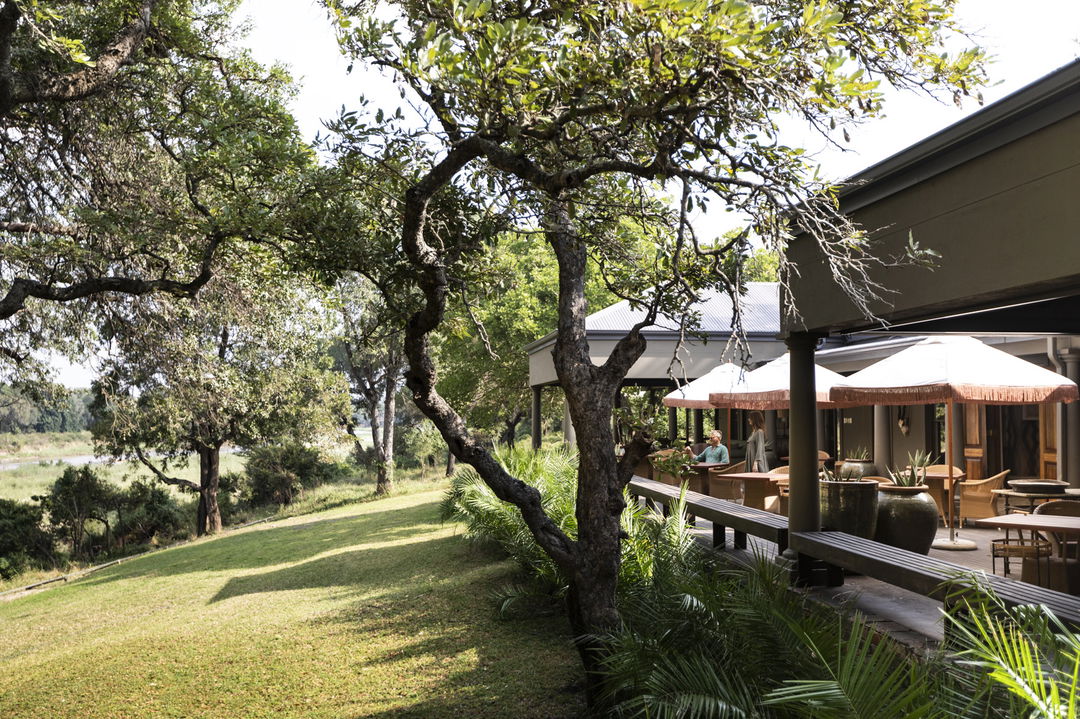 outside view of main deck at lodge from river at Rattrays camp MalaMala game Reserve