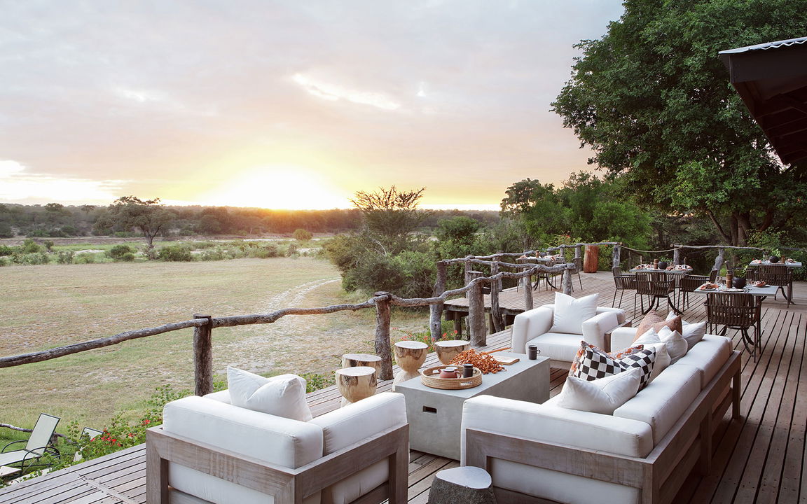 couches on deck of sable camp malamala at sunset