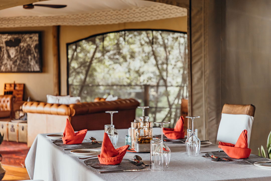 table set for dinner in dining area of Mara Plains Camp Kenya Masai Mara
