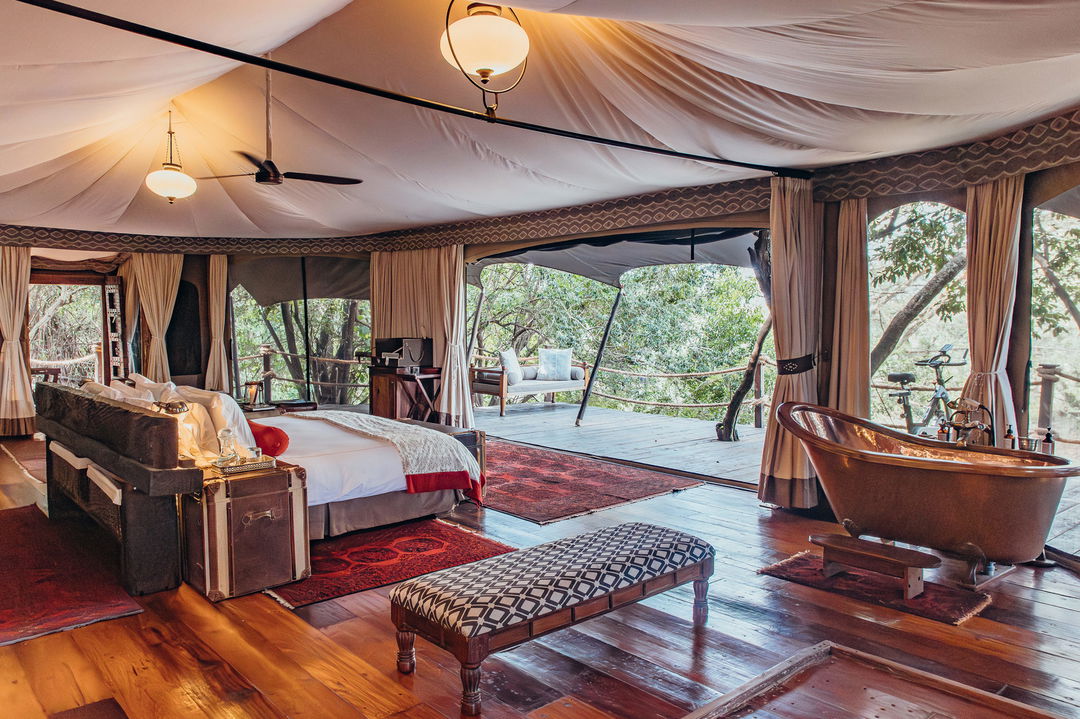 view of suite interior and deck leading out at Mara Plains Camp Kenya Masai Mara