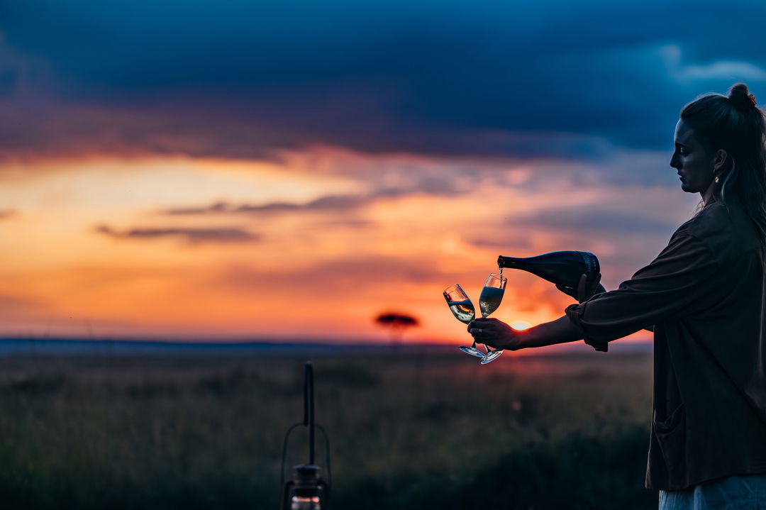 champagne sundowners on the plains at sunset by Mara Plains Camp Kenya Masai Mara