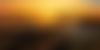 sun setting over Okavango delta with mokoros on riverbank in foreground